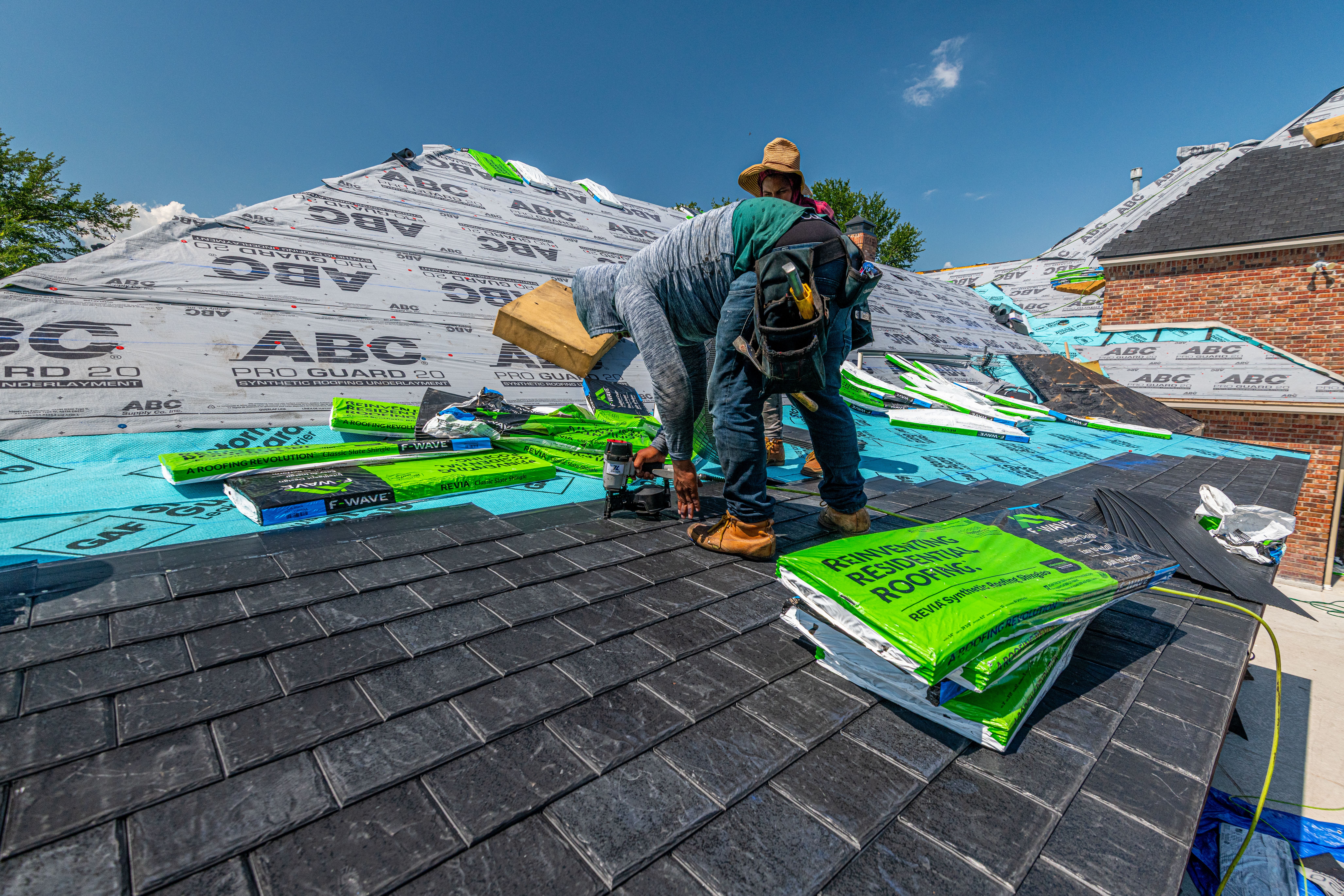 Roofing crew working on a residential roof